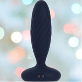 Set against a blurred backdrop of multicolored lights, the navy blue Svakom Jordan Vibrating Anal Stimulator with its wide base highlights its cutting-edge features. Effortlessly connect to the SVAKOM App or indulge in the thrilling thrusting and vibrating functions for an unmatched experience.
